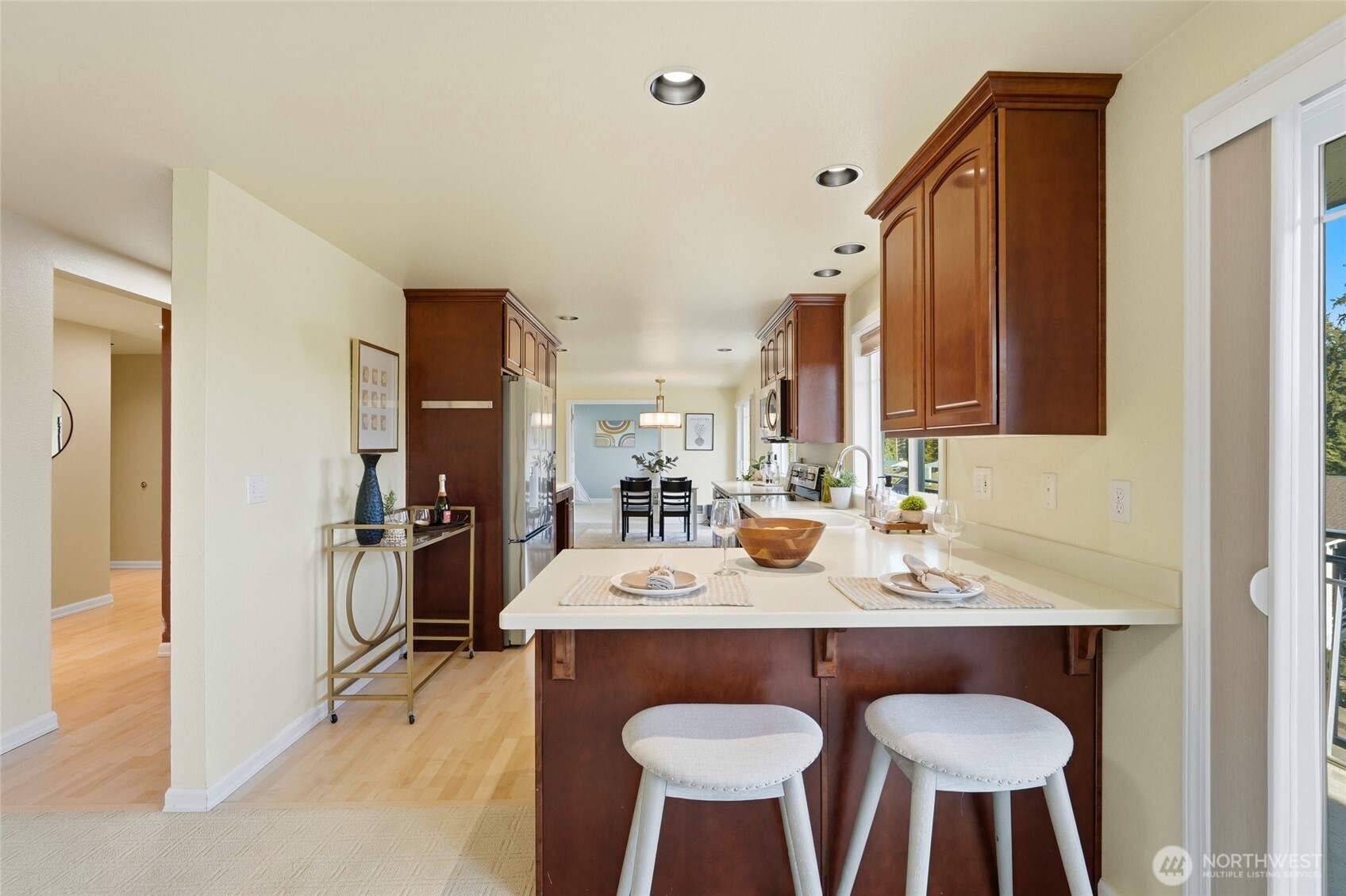 7503 212th Street Southwest, Unit B302 Edmonds, WA 98026 - Photo 11 of 28 a view of kitchen island dining table and chairs