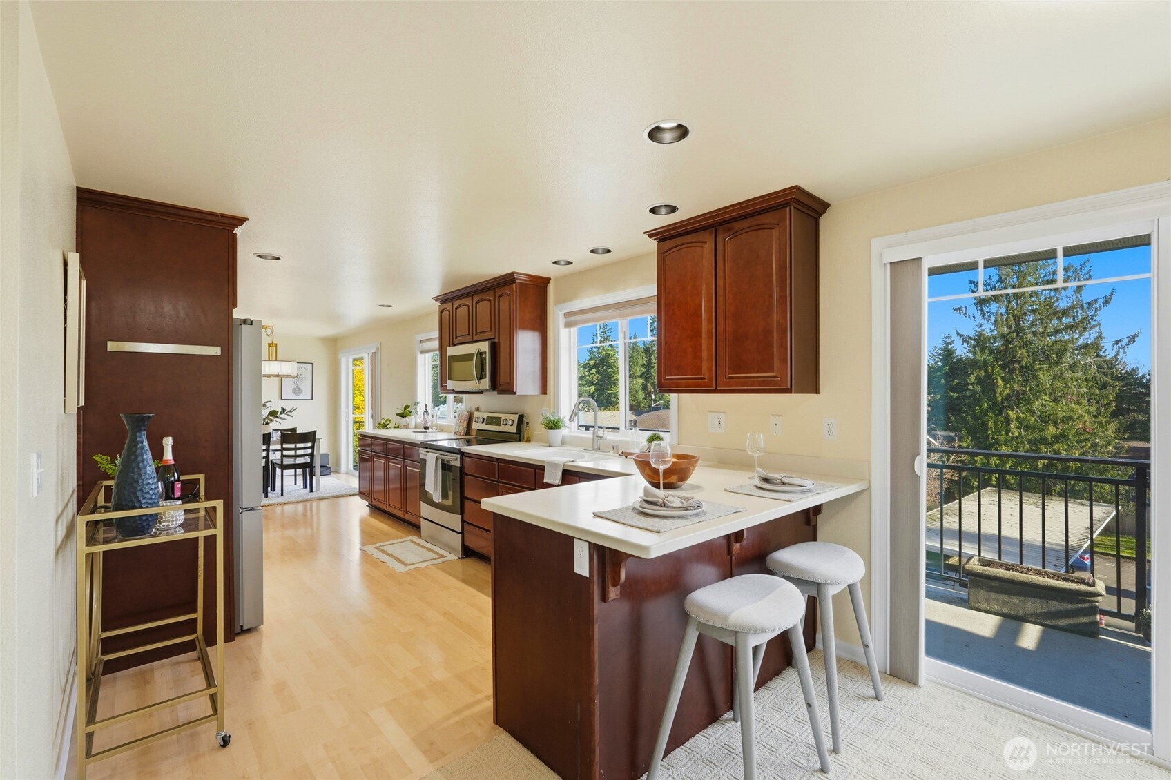 7503 212th Street Southwest, Unit B302 Edmonds, WA 98026 - Photo 12 of 28 a kitchen with a sink refrigerator and cabinets