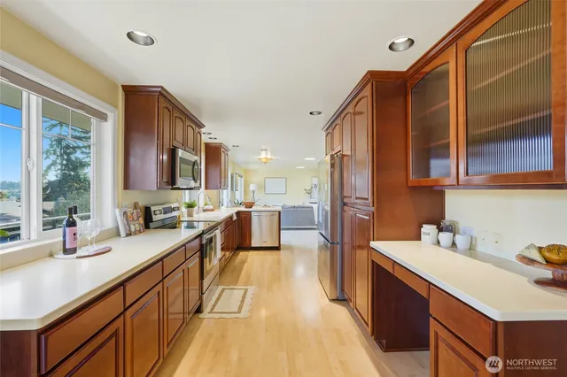 a kitchen with stainless steel appliances a sink stove and cabinets