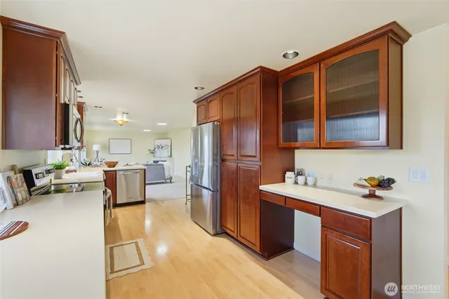 a kitchen view with stainless steel appliances kitchen island granite countertop lots of counter top space and furniture