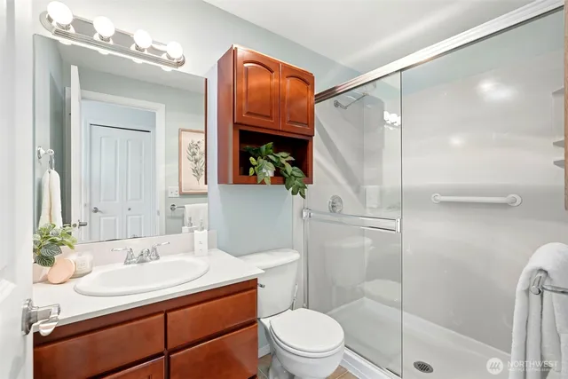 a bathroom with a sink a toilet and shower