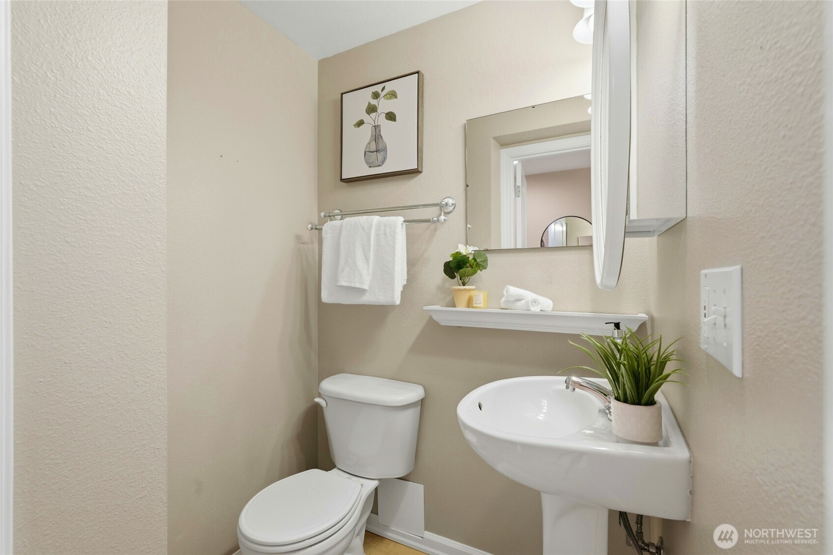 7503 212th Street Southwest, Unit B302 Edmonds, WA 98026 - Photo 25 of 28 a bathroom with a toilet a sink and mirror
