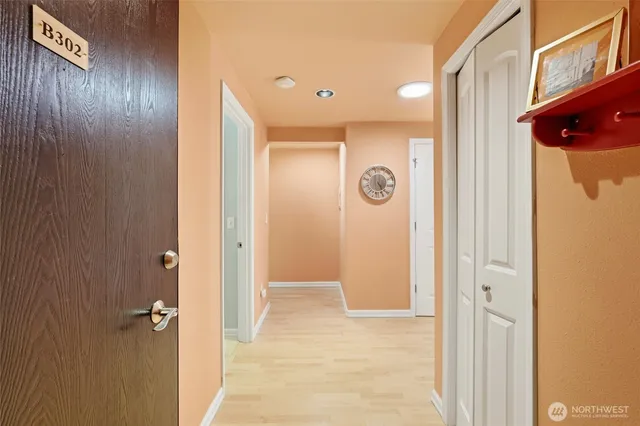a view of a hallway with wooden shelves