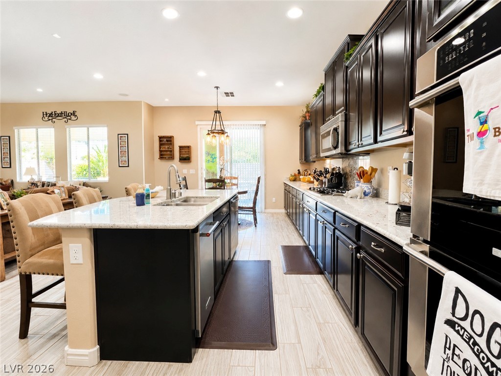 9724 University Ridge Avenue Las Vegas, NV 89149 - Photo 9 of 61 Culinary delights await in this bright kitchen, complete with a generous island and ample cabinetry.