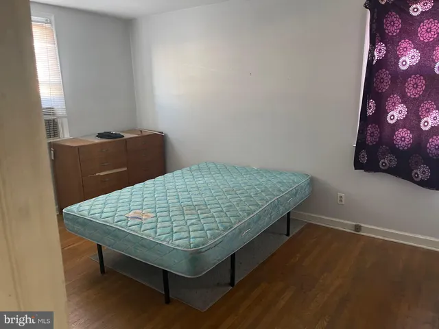 a wooden bench sitting in a room next to a window