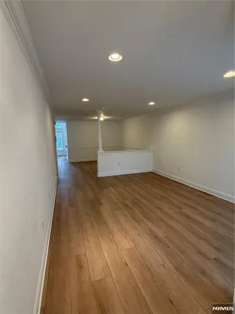 a view of staircase with wooden floor and a chandelier