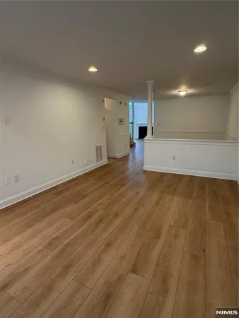 an empty room with a window and a fan