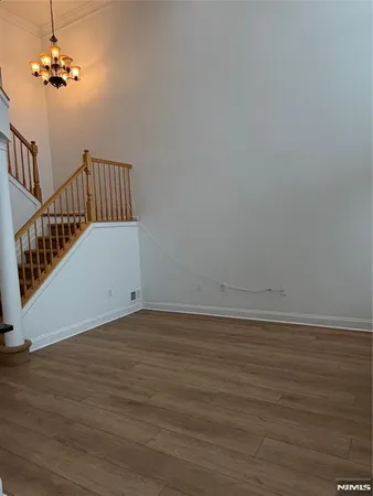 an empty room with windows and ceiling fan