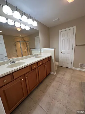 a bathroom with a tub a sink and a shower