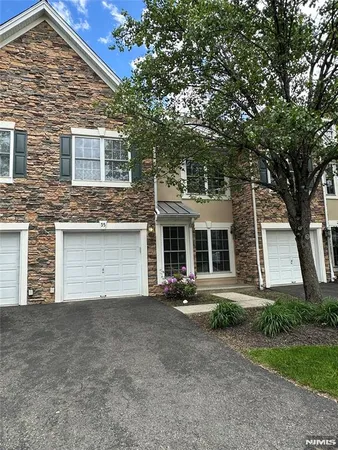 front view of a house with a tree