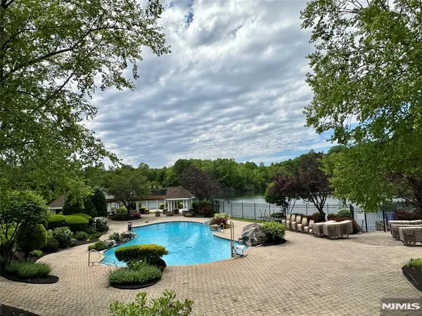 a view of a swimming pool with furniture