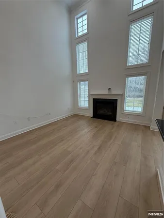 a kitchen with stainless steel appliances granite countertop wooden cabinets a stove a sink and dishwasher with wooden floor