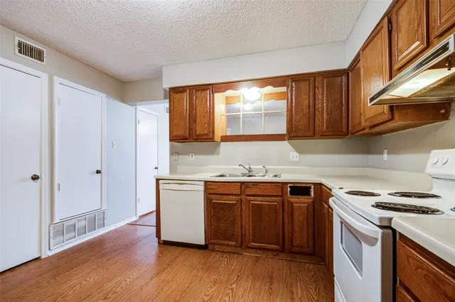 a kitchen with stainless steel appliances granite countertop a stove and a sink