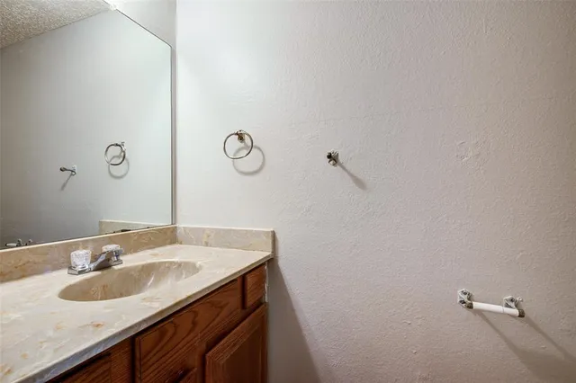 a bathroom with a sink and mirror