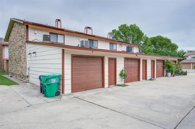 a front view of a house with potted plants