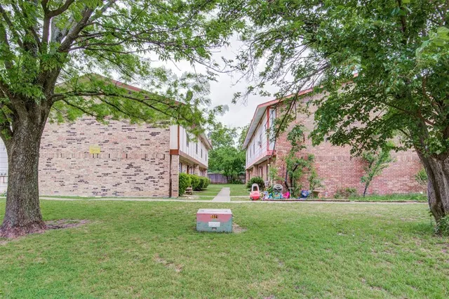 a view of green field with trees in the background