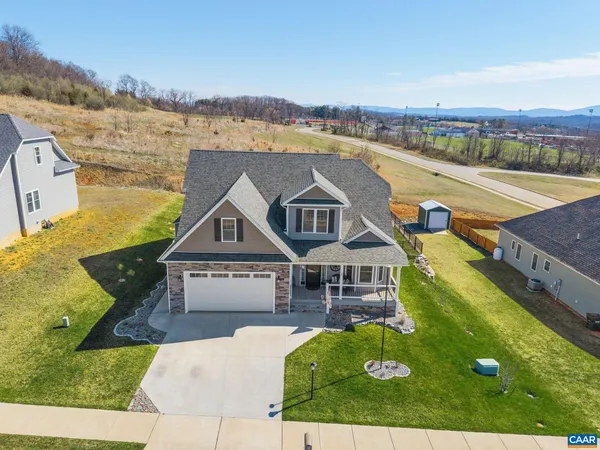 an aerial view of a house with a big yard