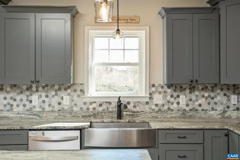 a kitchen with granite countertop a sink and a window