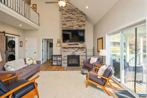 a living room with furniture and kitchen view