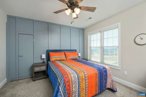 a bedroom with a white bed and white walls