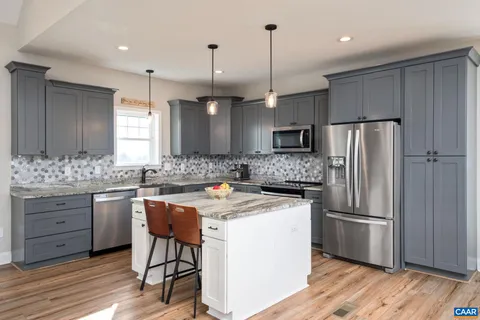 a kitchen with a refrigerator a sink and a wooden cabinets