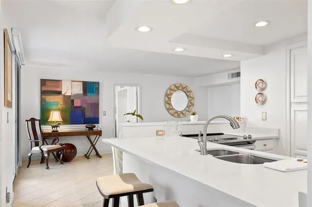 a kitchen with stainless steel appliances granite countertop a stove and a sink