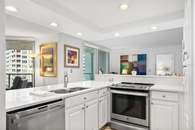 a kitchen with a sink stove and cabinets