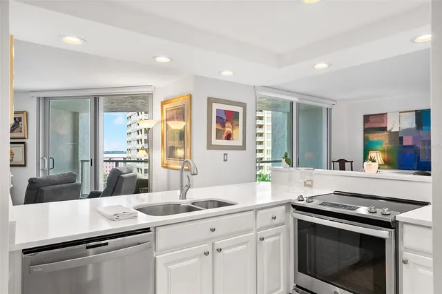 a living room with furniture a table and large windows