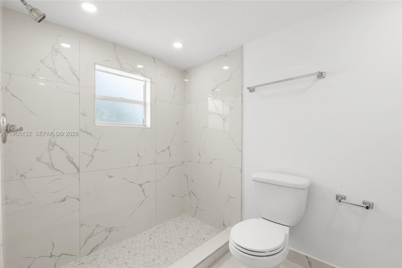 2385 Southwest 17th Street Miami, FL 33145 - Photo 12 of 28 a white toilet sitting next to a shower