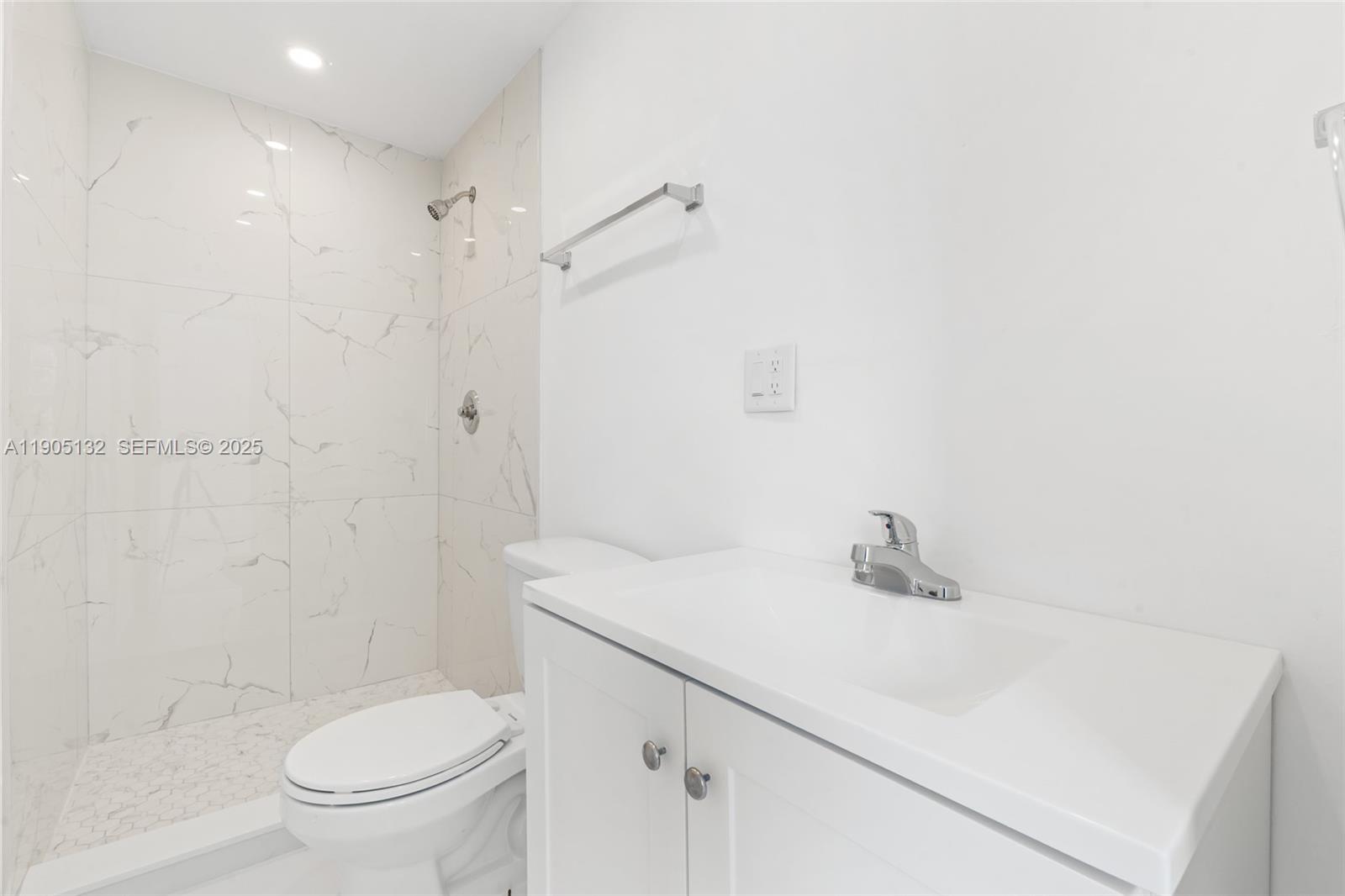 2385 Southwest 17th Street Miami, FL 33145 - Photo 13 of 28 a bathroom with a sink a toilet and shower