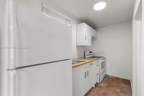 a utility room with cabinets washer and dryer