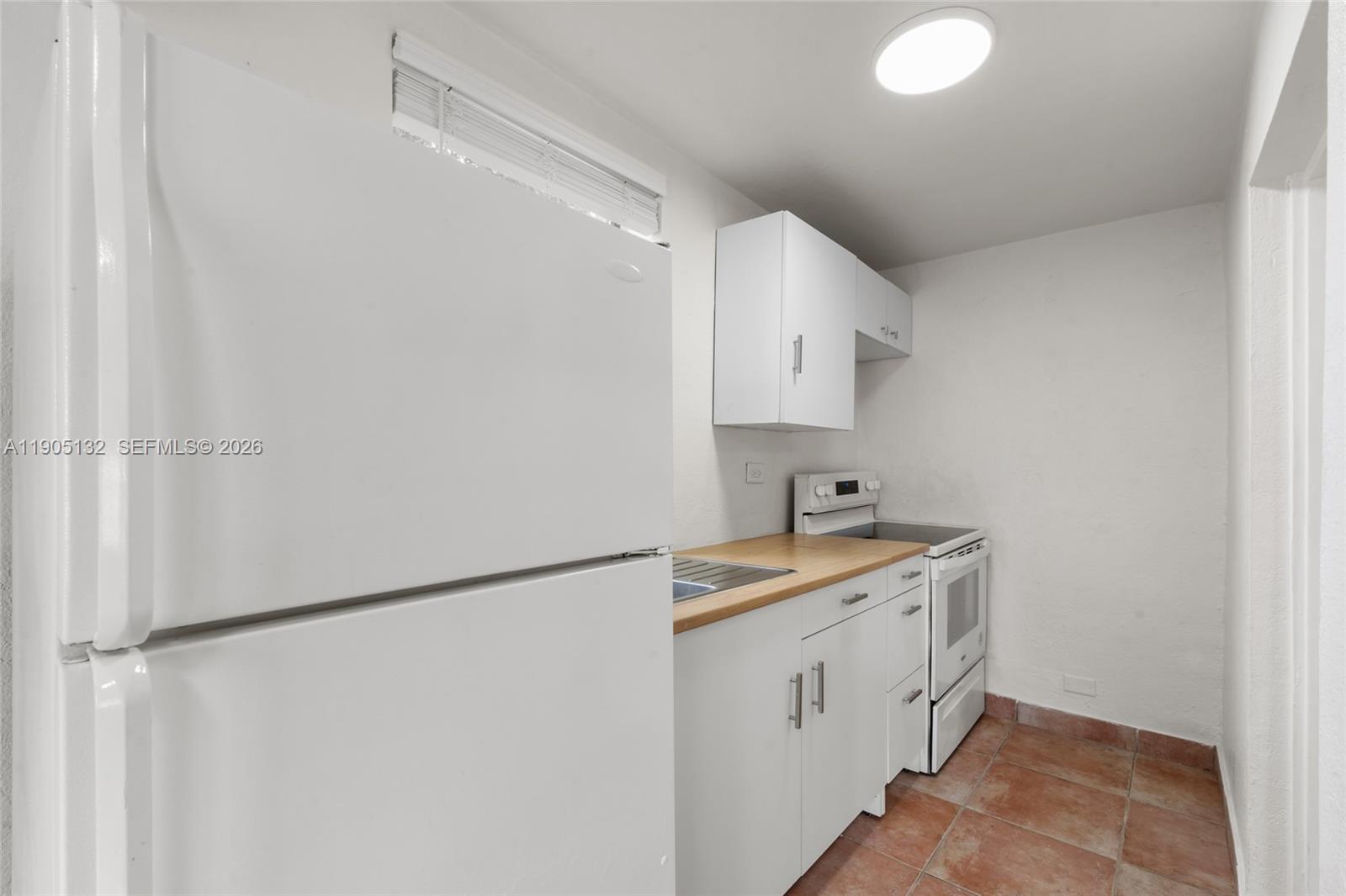 2385 Southwest 17th Street Miami, FL 33145 - Photo 18 of 28 a utility room with cabinets washer and dryer