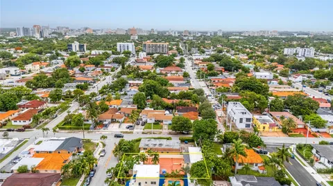 an aerial view of residential houses with city view