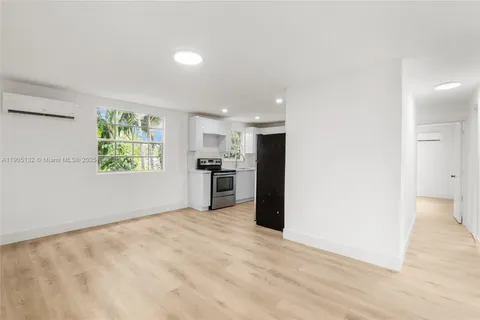 a view of kitchen with window and refrigerator