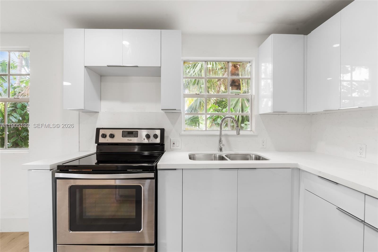 2385 Southwest 17th Street Miami, FL 33145 - Photo 9 of 28 a kitchen with a sink stove and cabinets