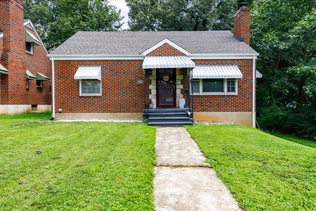 a front view of a house with a garden