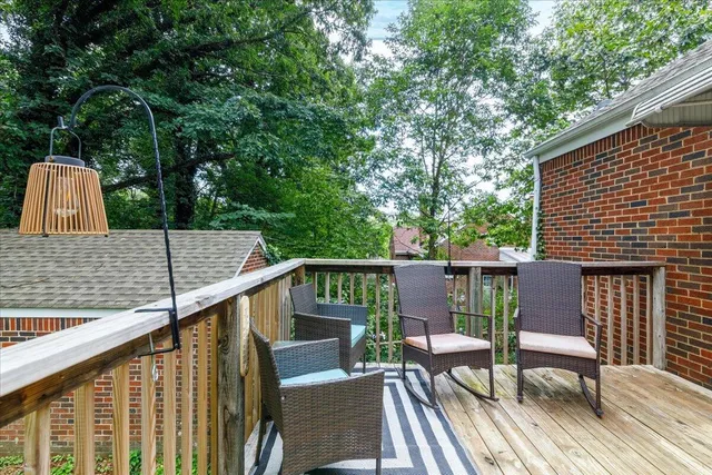 a view of deck with furniture and trees