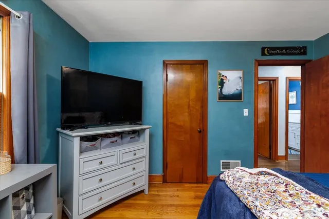 a bedroom with a bed and flat screen tv