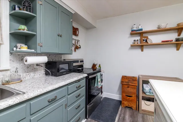 a kitchen with sink and cabinets