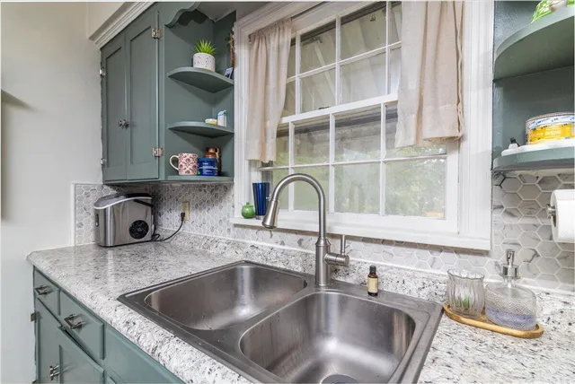 a kitchen with kitchen island a sink and a stove with wooden floor