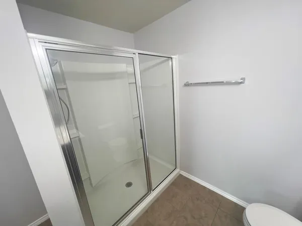 a bathroom with a glass shower door