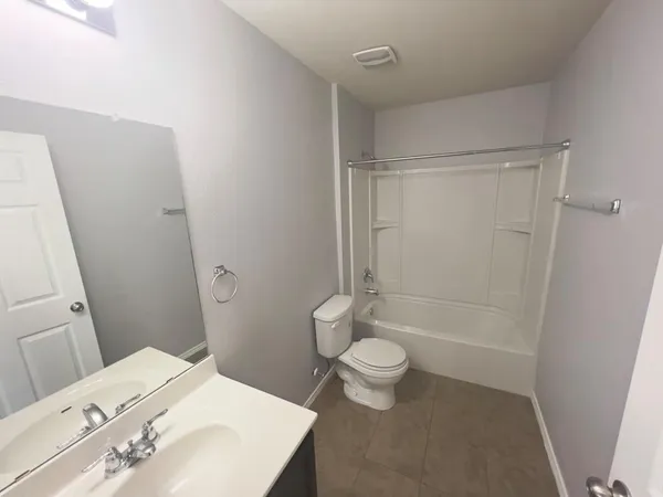 a bathroom with a shower a toilet and a sink