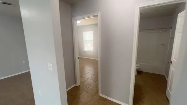 a view of a bathroom from a hallway