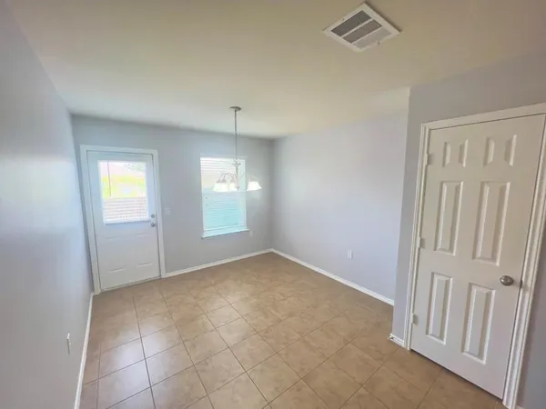 an empty room with windows and closet