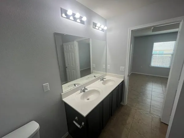 a bathroom with a sink toilet and mirror