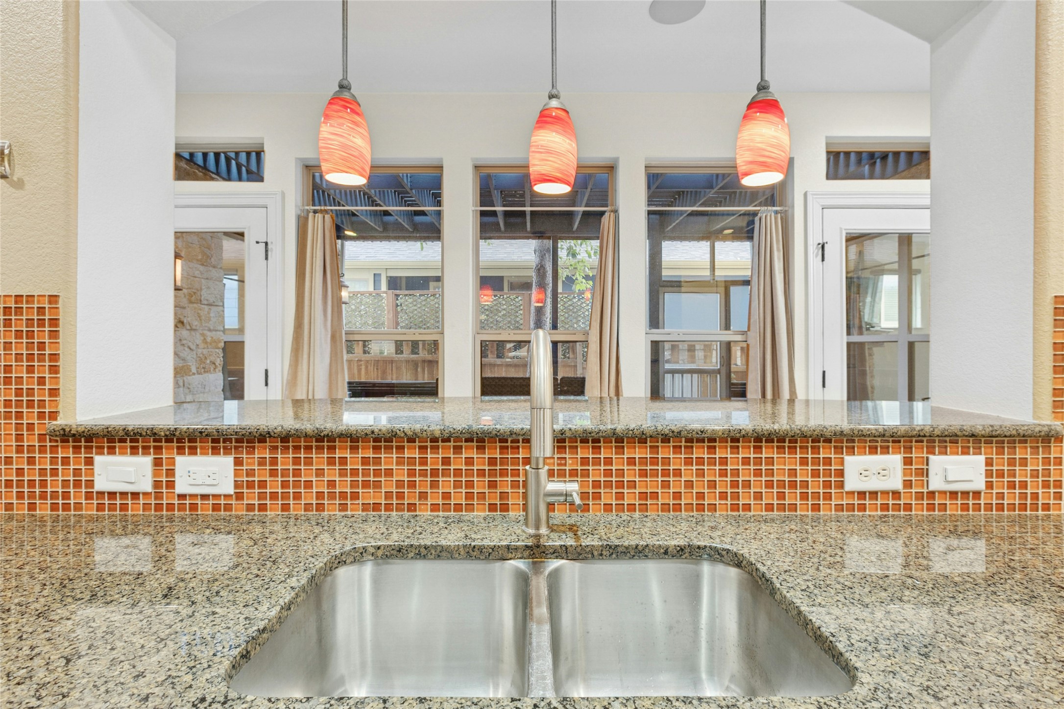 1912 Antone Street Austin, TX 78723 - Photo 11 of 38 Kitchen with light stone countertops and decorative light fixtures