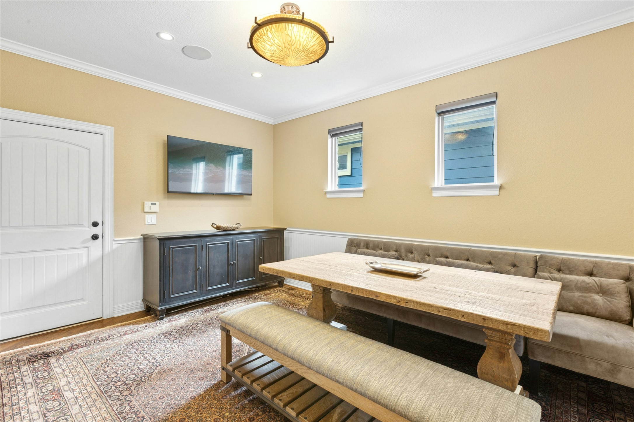 1912 Antone Street Austin, TX 78723 - Photo 13 of 38 Dining room featuring wood finished floors, a wainscoted wall, crown molding, and recessed lighting