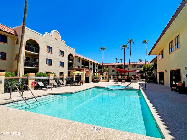 a view of a swimming pool with outdoor seating and a yard
