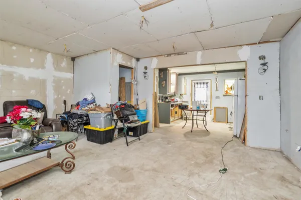 a kitchen with refrigerator a table and chairs
