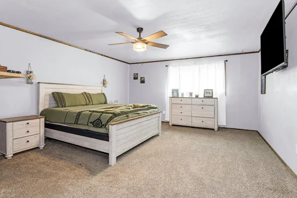 a bedroom with a bed and a chandelier